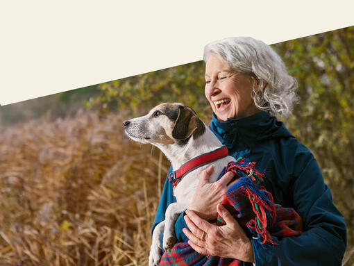 Older lady holding her dog 